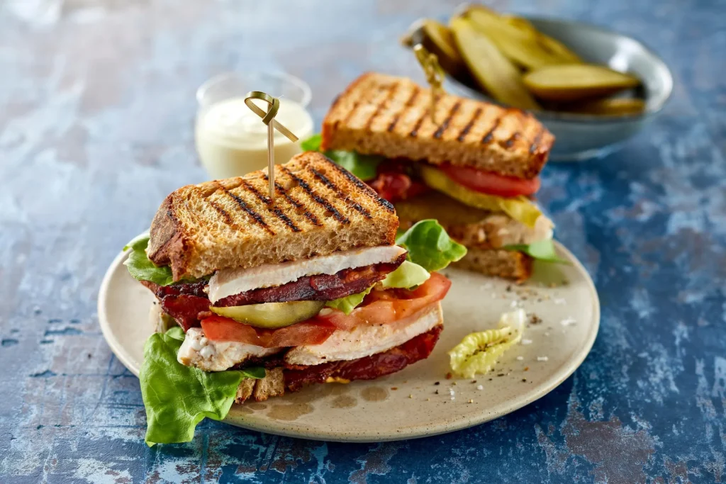 A crispy Halloumi Breakfast Sandwich with fried egg, avocado, and chili jam.