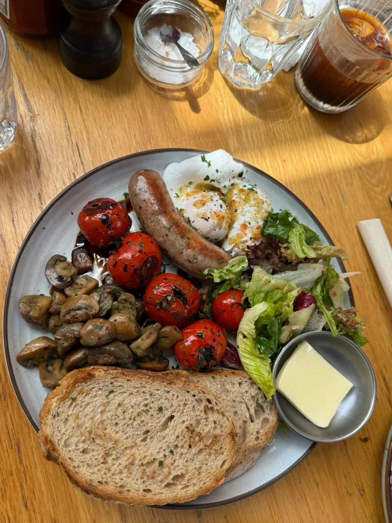 Traditional Full English breakfast with eggs, bacon, and sausages.