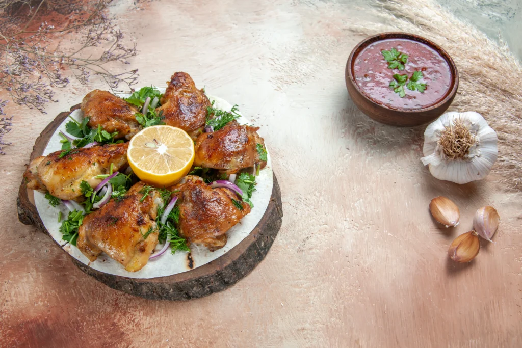 Spicy peri-peri chicken served with herbs and citrus wedges