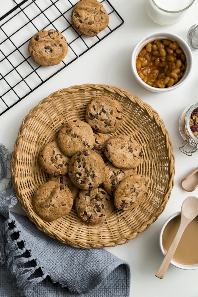 Chocolate chip cookie being pulled apart to reveal a gooey, melty center.
