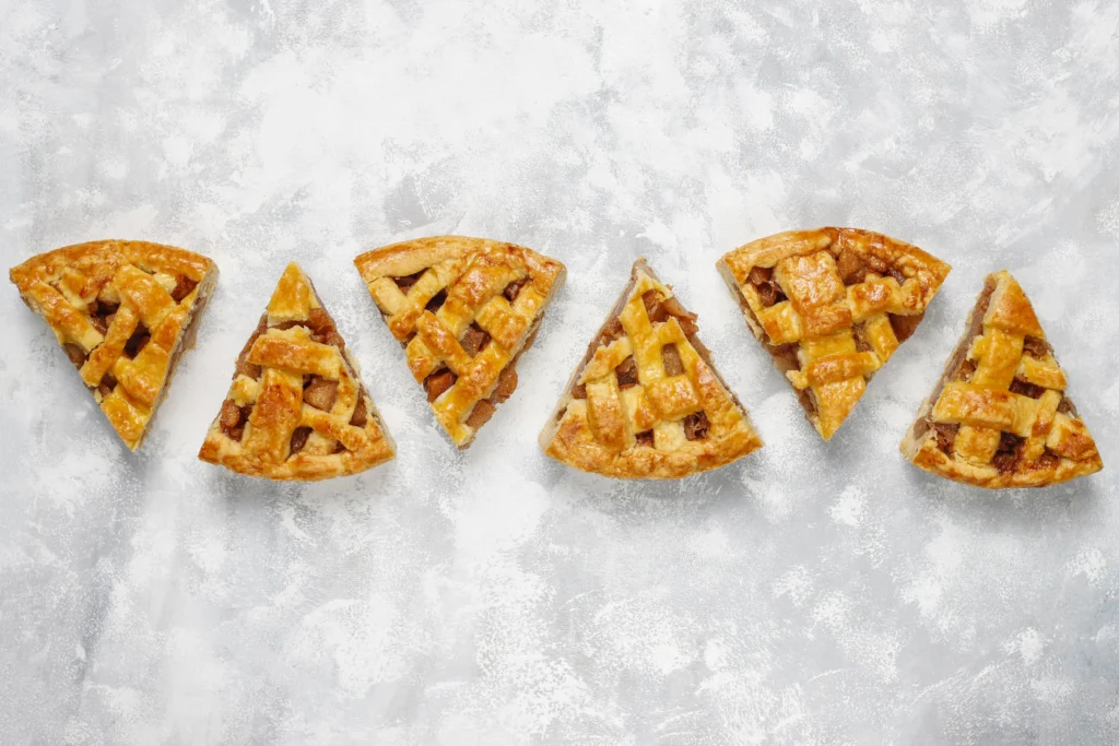 Shortcrust pastry dough being pressed into a tart tin, showing the smooth, pale, and buttery texture