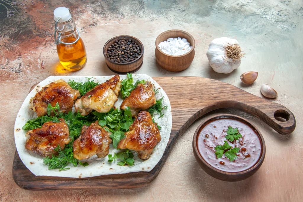 Spicy garlic chicken thighs served in a cast-iron skillet, drizzled with red chili oil and garnished with toasted garlic chips