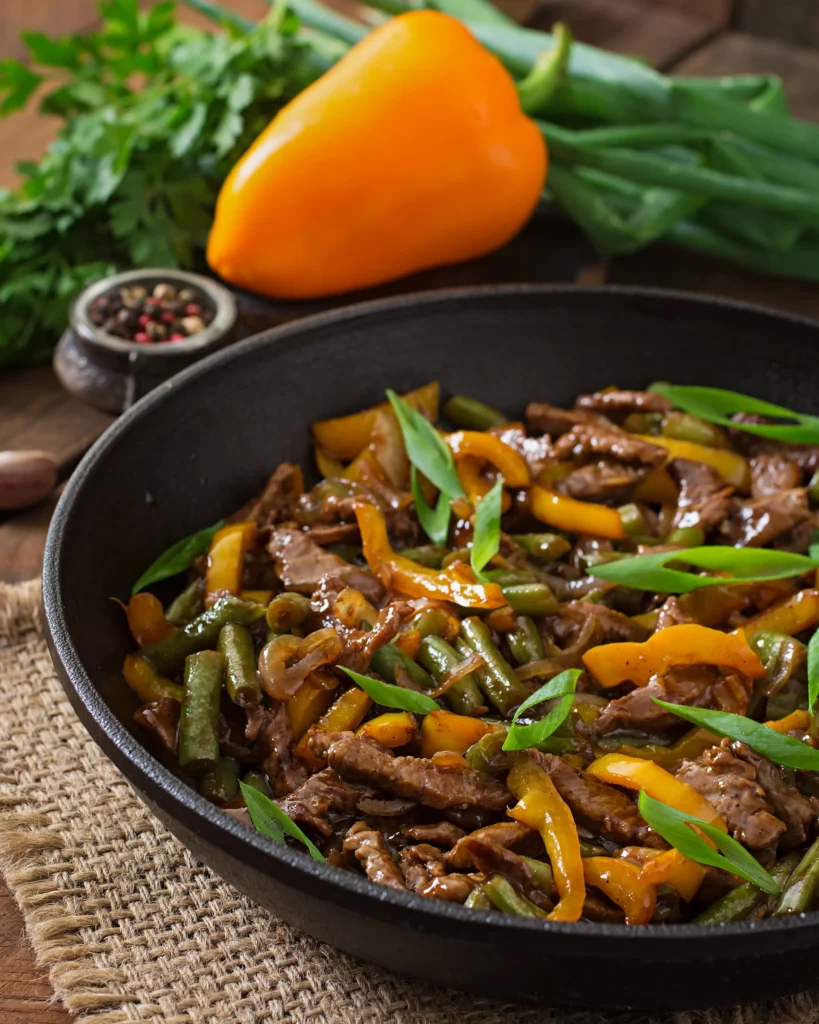 Ground beef stir fry close-up with a drizzle of spicy sriracha