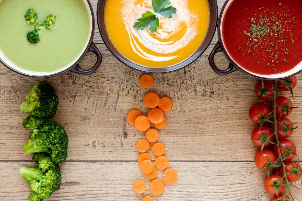 A steaming bowl of homemade chicken noodle soup on a rustic wooden table, lit by warm natural light, welcoming readers to a collection of authentic, soul-warming recipes