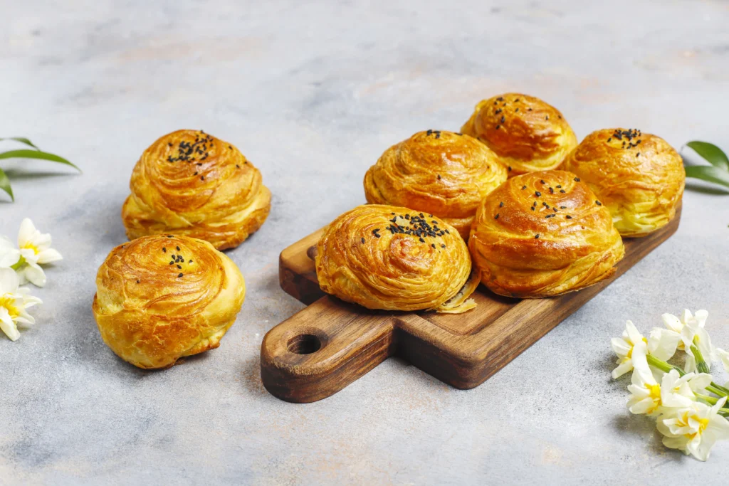 Puff pastry appetizers arranged on a cooling rack, showing layers of flaky, golden-brown dough