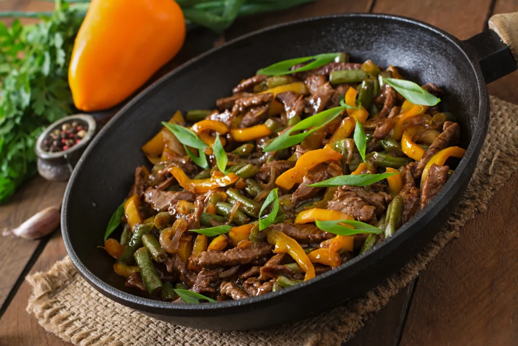 Healthy 20-minute ground beef stir fry with mixed vegetables in a cast iron skillet.